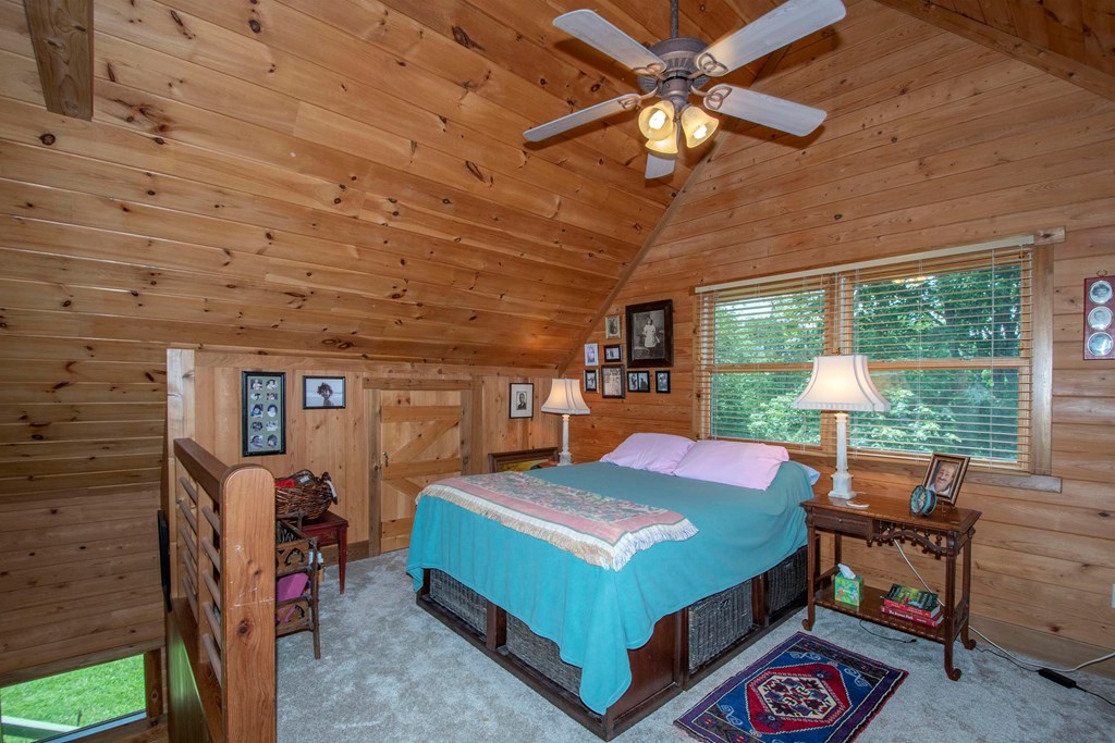 41 Pine Trail Warne, NC 28909 - Photo 30 of 43 a bedroom with a bed a large window and walk in closet