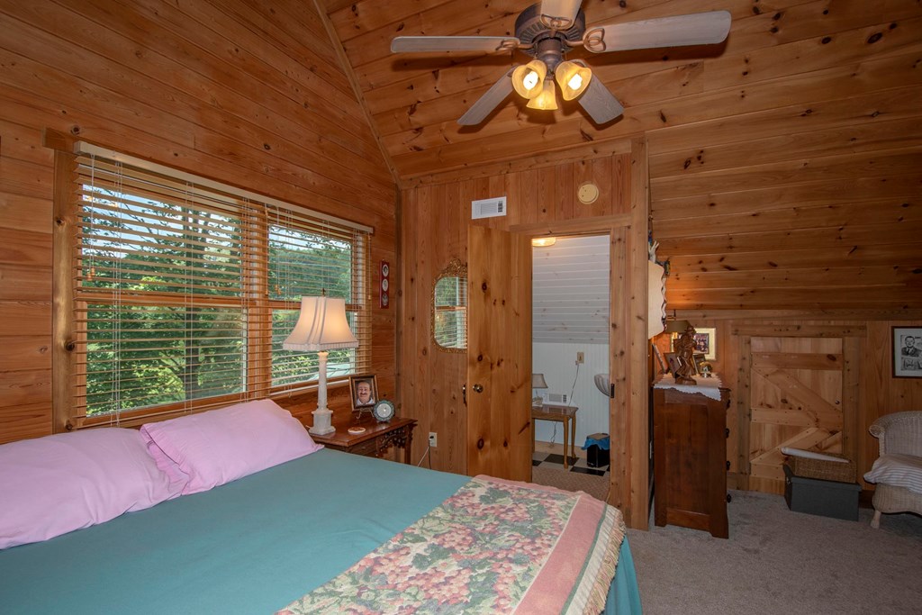 41 Pine Trail Warne, NC 28909 - Photo 31 of 43 a bedroom with furniture and a chandelier