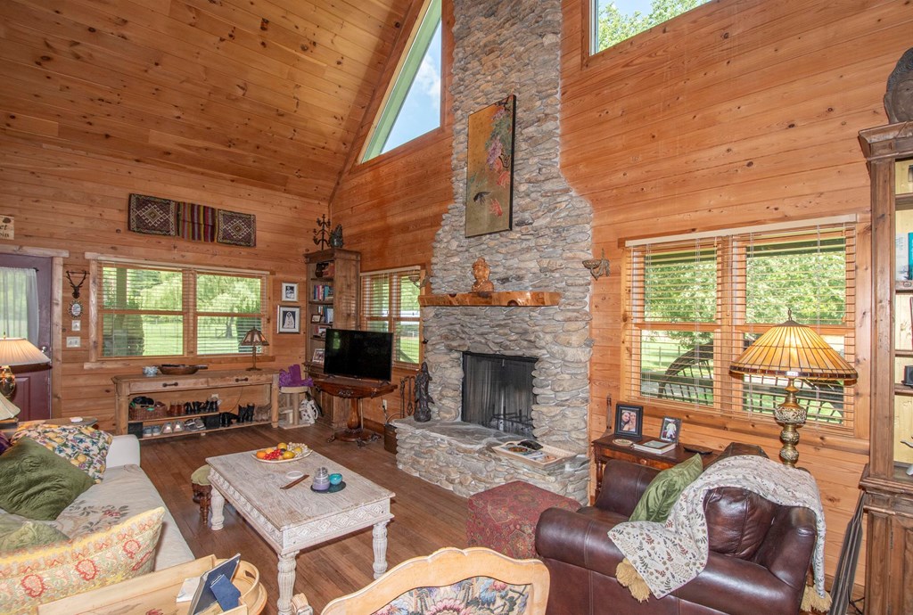 41 Pine Trail Warne, NC 28909 - Photo 42 of 43 a living room with furniture a fireplace and a floor to ceiling window