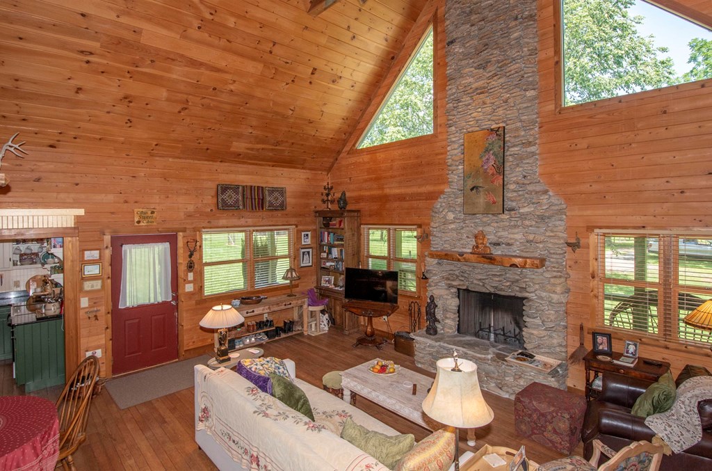 41 Pine Trail Warne, NC 28909 - Photo 43 of 43 a living room with furniture a fireplace and a floor to ceiling window