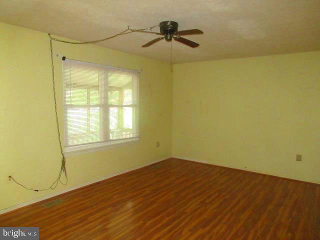 665 Flagstaff Road Lusby, MD 20657 - Photo 9 of 11 a view of a big room with wooden floor and chandelier fan