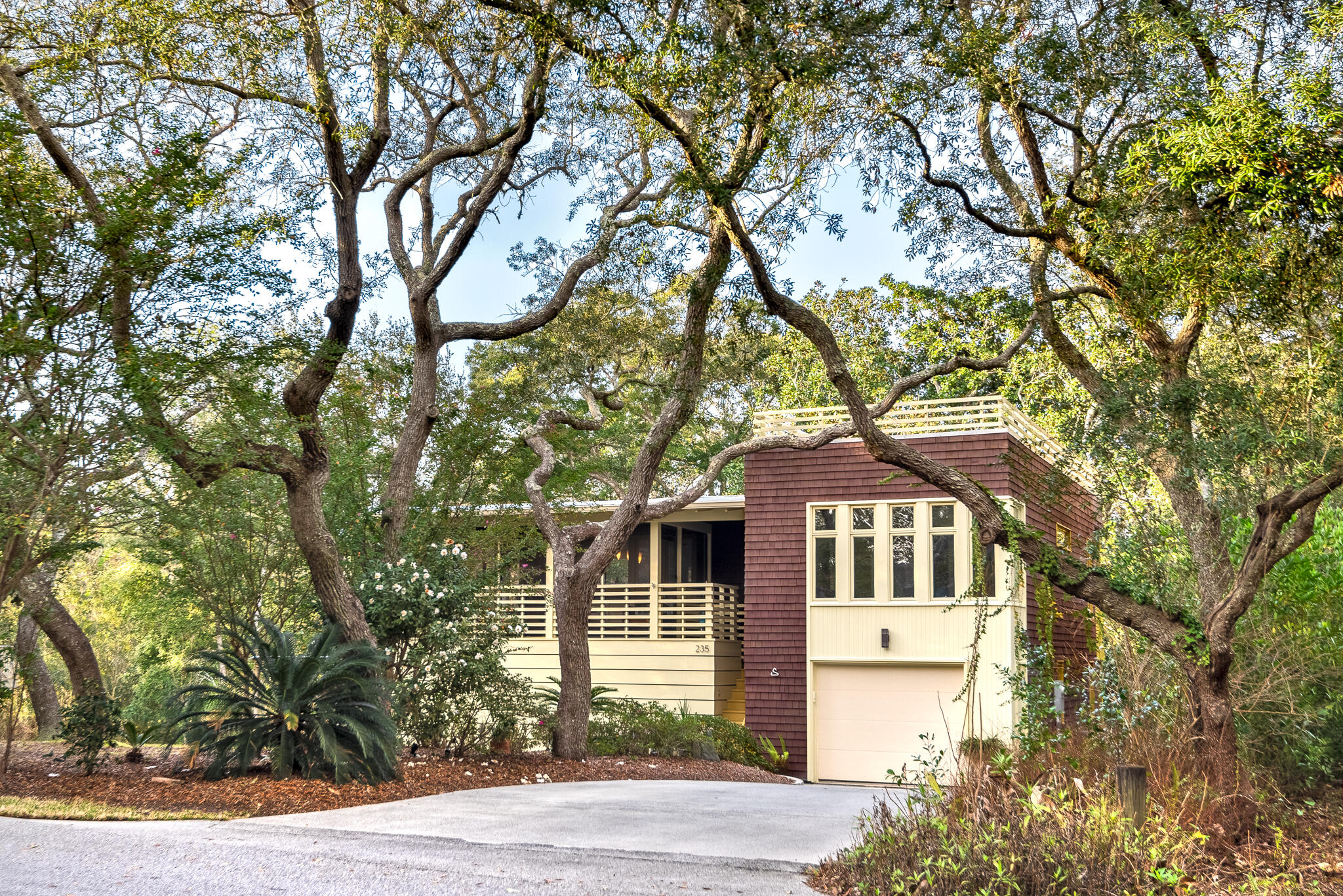 235 North Bishop Road Santa Rosa Beach, FL 32459 - Photo 3 of 68 a front view of a house with a garden