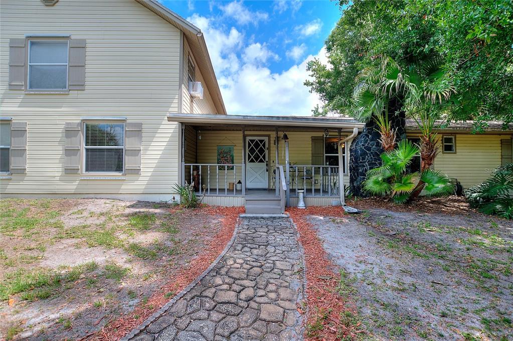 3641 Turtle Mound Road Melbourne, FL 32934 - Photo 4 of 77 a view of a brick house with many windows next to a yard