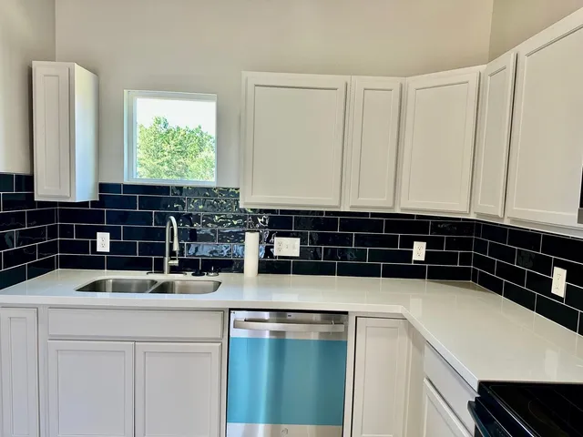 a kitchen with a sink and cabinets