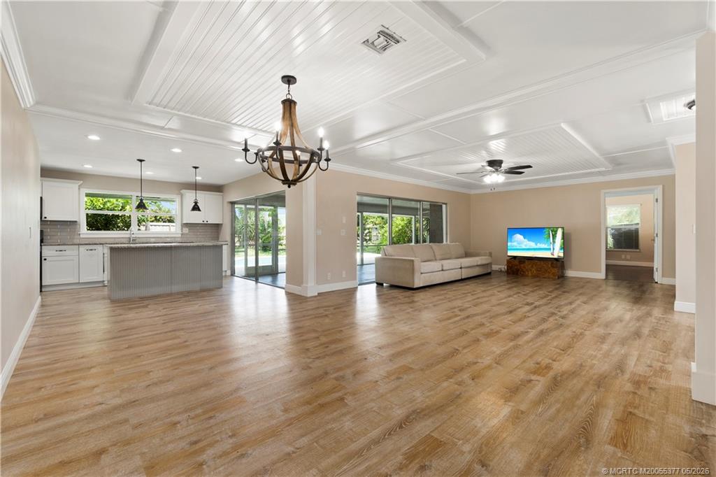 53 North Sewalls Point Road Sewall's Point, FL 34996 - Photo 11 of 55 a view of a living room and kitchen with furniture wooden floor