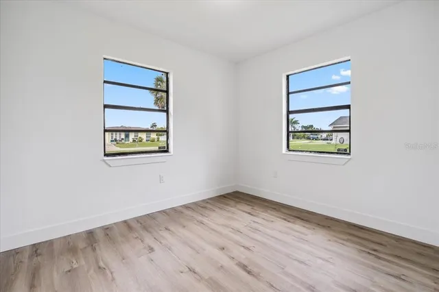 an empty room with a workspace and a window