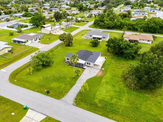 an aerial view of residential houses with outdoor space and swimming pool