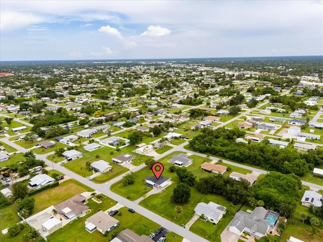 an aerial view of residential houses with outdoor space