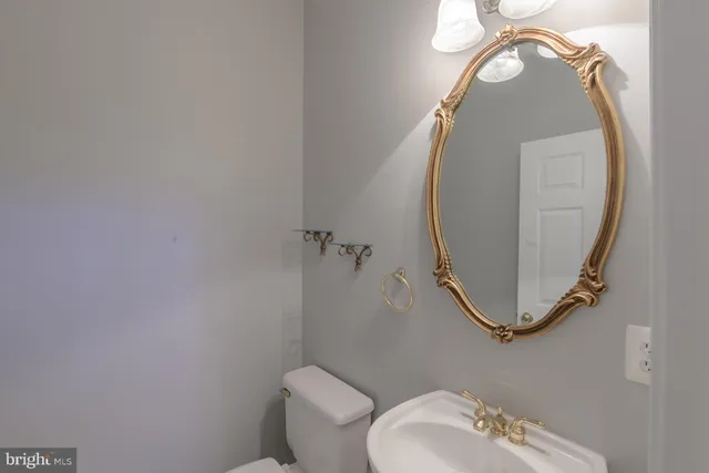 a bathroom with a toilet and a mirror