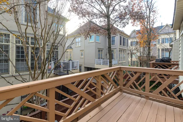 a view of a roof deck with wooden floor and fence