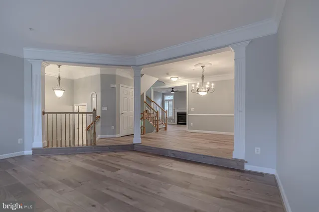 a view of a room with wooden floor and an entryway
