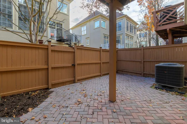 a view of a house with a wooden fence