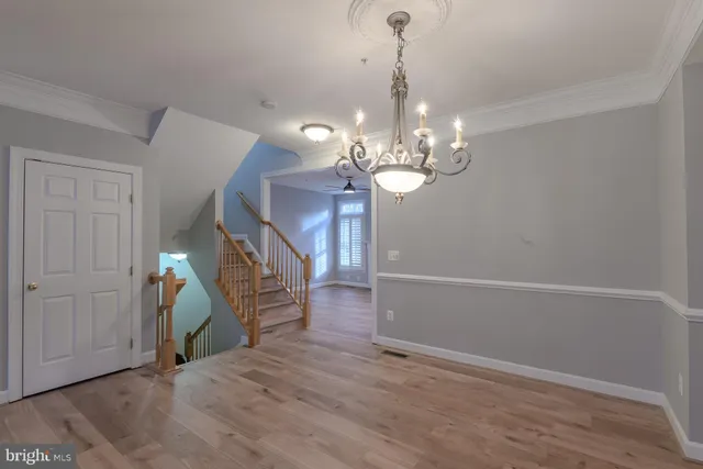 a view of a livingroom with wooden floor and stairs