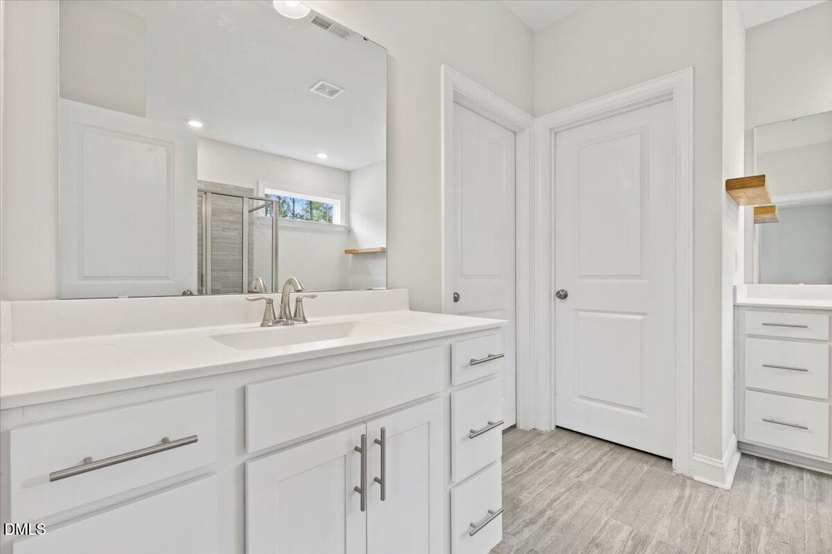 4937 Abundance Avenue Raleigh, NC 27616 - Photo 19 of 36 a bathroom with a sink and a mirror