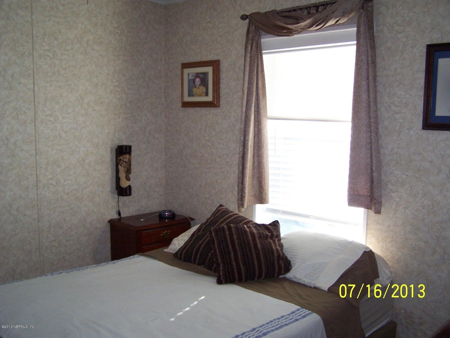 54210 Hurst Road Callahan, FL 32011 - Photo 3 of 12 a bedroom with a bed and a window