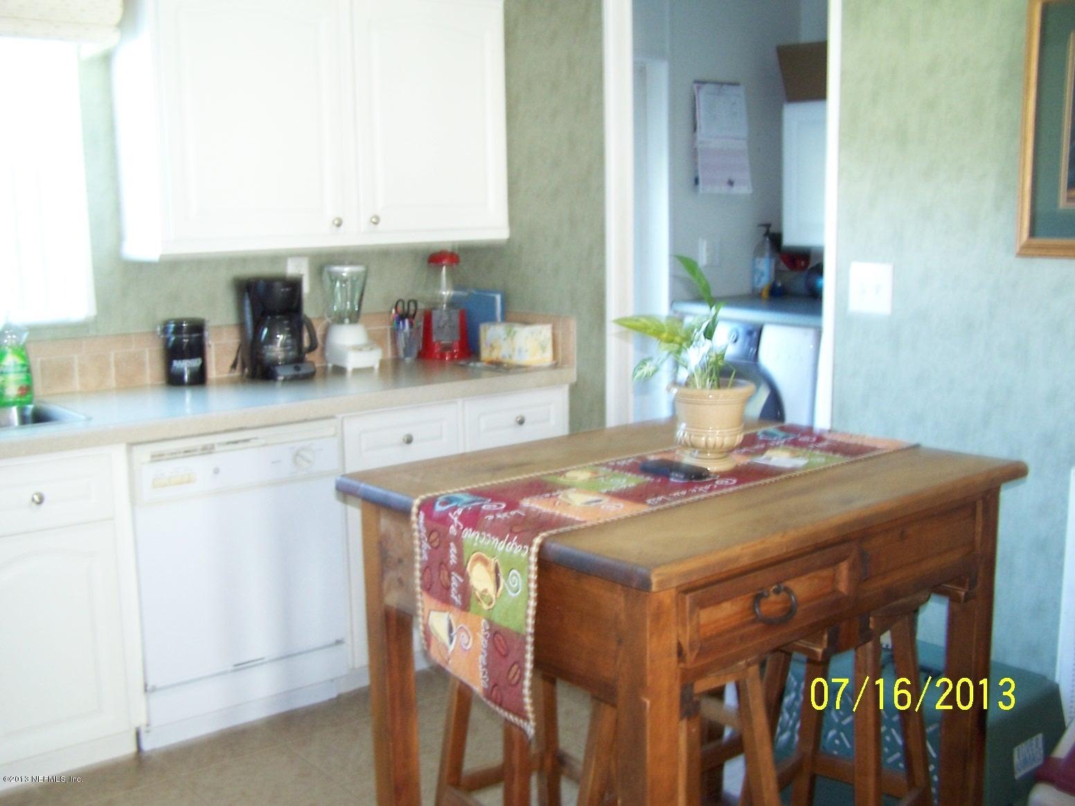 54210 Hurst Road Callahan, FL 32011 - Photo 5 of 12 a kitchen with a table and chairs in it