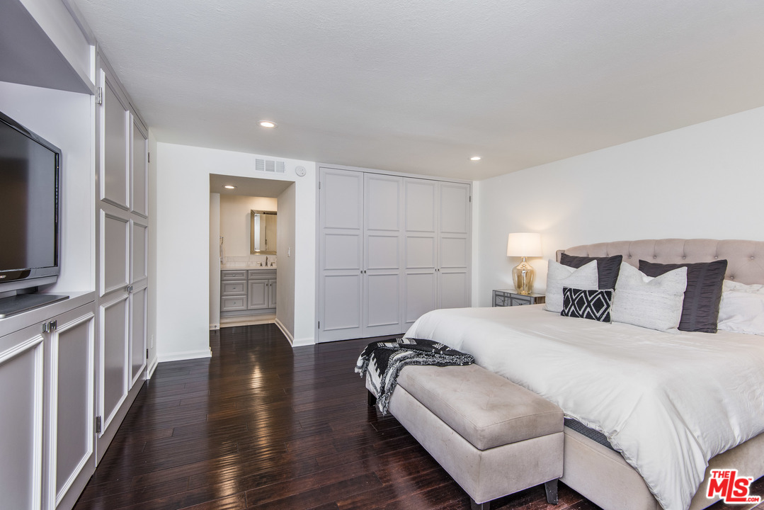 4200 Vía Dolce, Unit 129 Marina del Rey, CA 90292 - Photo 14 of 30 a spacious bedroom with a bed and a flat screen tv