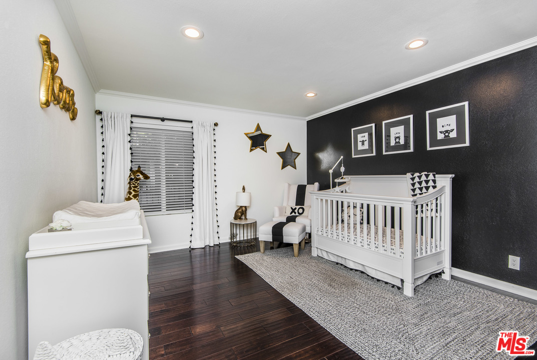 4200 Vía Dolce, Unit 129 Marina del Rey, CA 90292 - Photo 15 of 30 a bedroom with furniture and a wooden floor