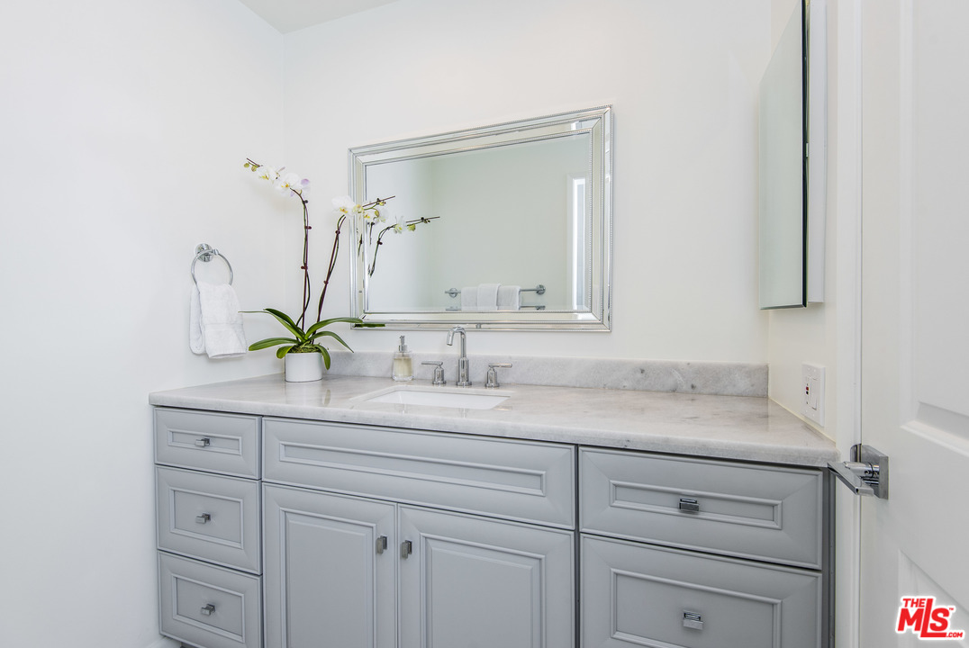 4200 Vía Dolce, Unit 129 Marina del Rey, CA 90292 - Photo 18 of 30 a bathroom with a sink and a mirror
