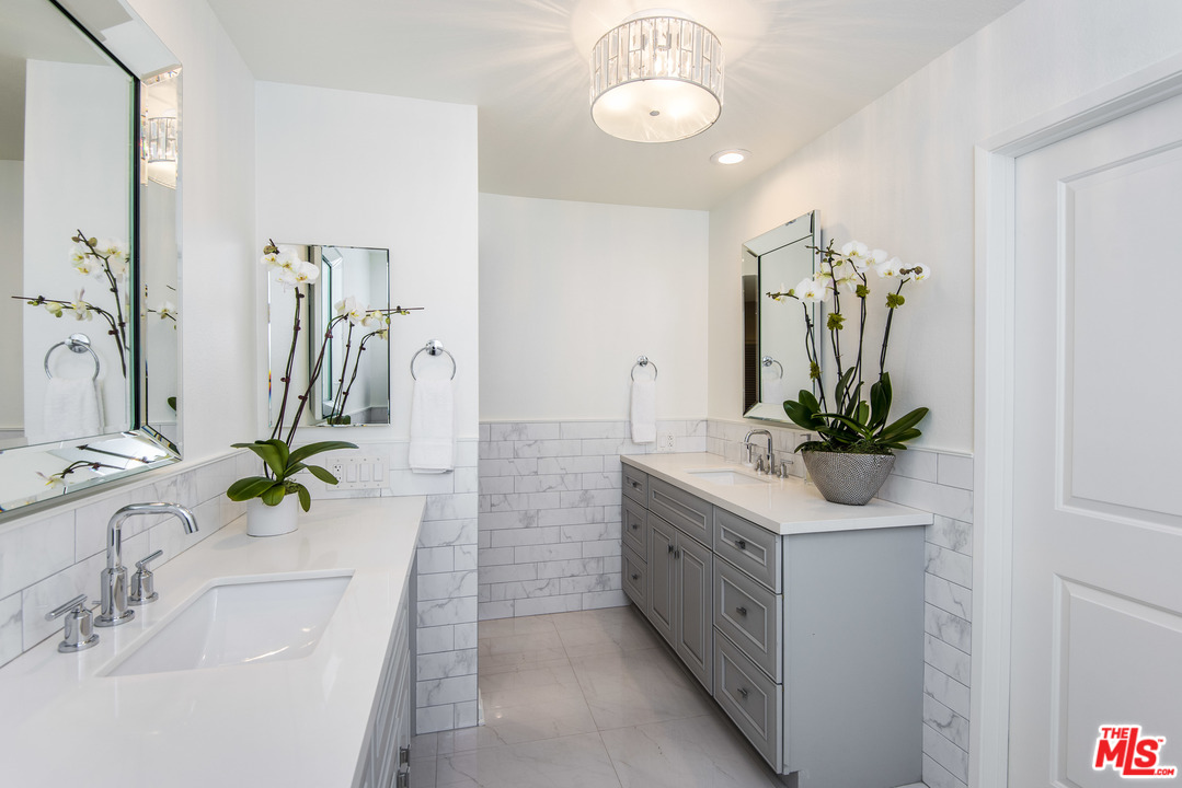 4200 Vía Dolce, Unit 129 Marina del Rey, CA 90292 - Photo 9 of 30 a bathroom with sink a mirror and a shower