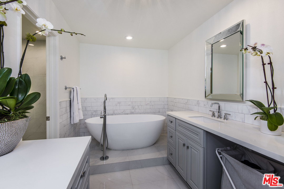 4200 Vía Dolce, Unit 129 Marina del Rey, CA 90292 - Photo 10 of 30 a bathroom with a tub sink and mirror