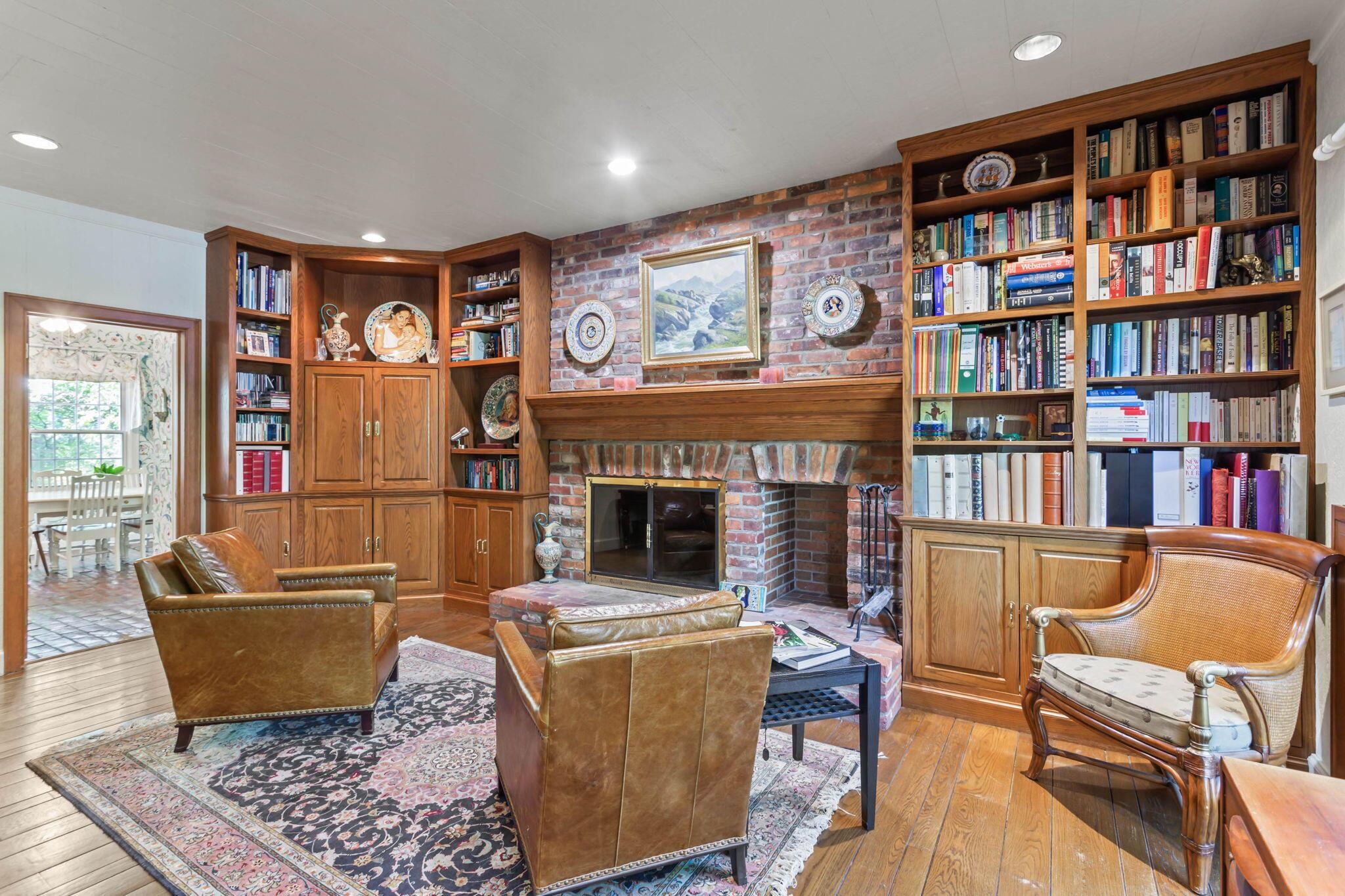 2111 Cheltenham Road Columbus, OH 43220 - Photo 11 of 64 Built in book cases surround the brick fireplace in the family room.
