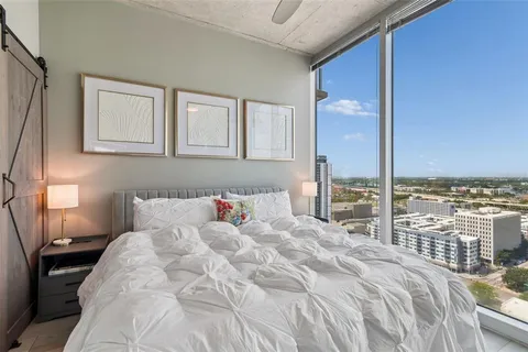 a dining room with furniture and a large window