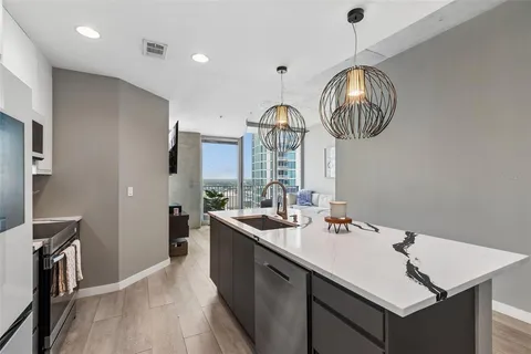 a living room with furniture and floor to ceiling windows