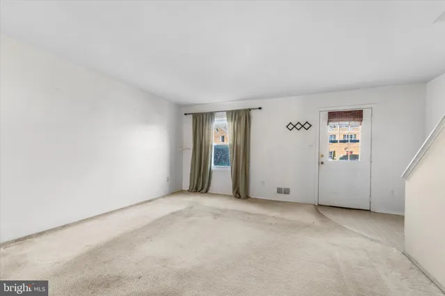 a kitchen with a refrigerator a stove a sink and a cabinets with wooden floor