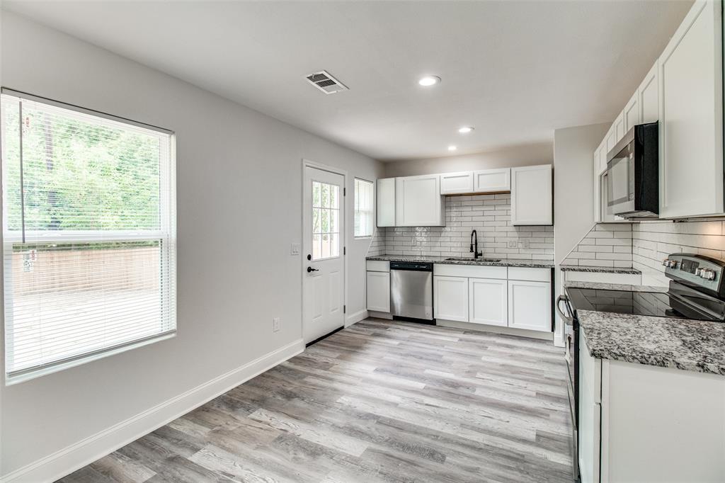 1201 Ridgewood Road Denison, TX 75020 - Photo 7 of 29 Kitchen with light stone counters, stainless steel appliances, sink, white cabinets, and light hardwood / wood-style flooring