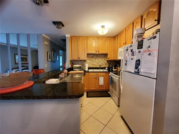 a kitchen with refrigerator and cabinets
