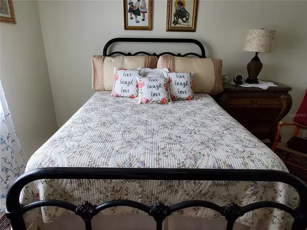 a bed with a black and white comforter