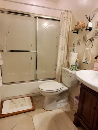 a white toilet sitting next to a bathroom sink