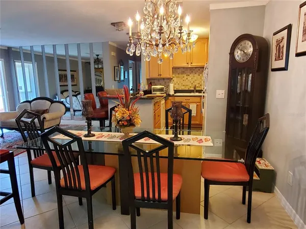 a view of a dining room with furniture and chandelier