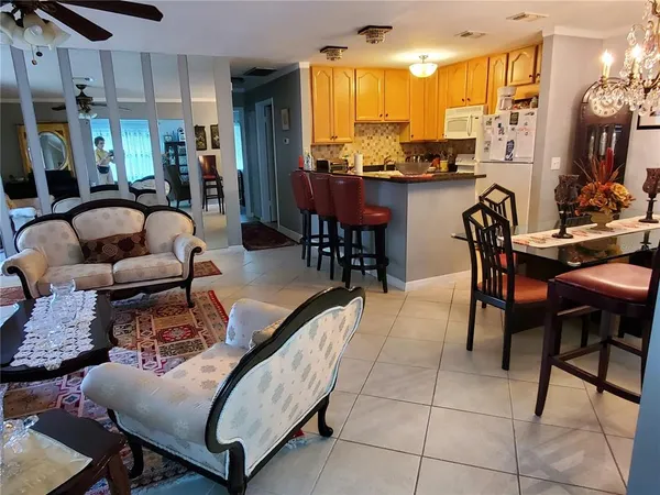 a living room kitchen with furniture and a large window