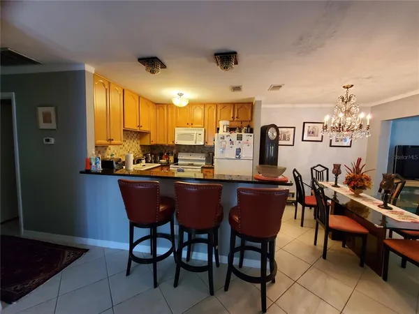 a dining room with a wooden table and chairs