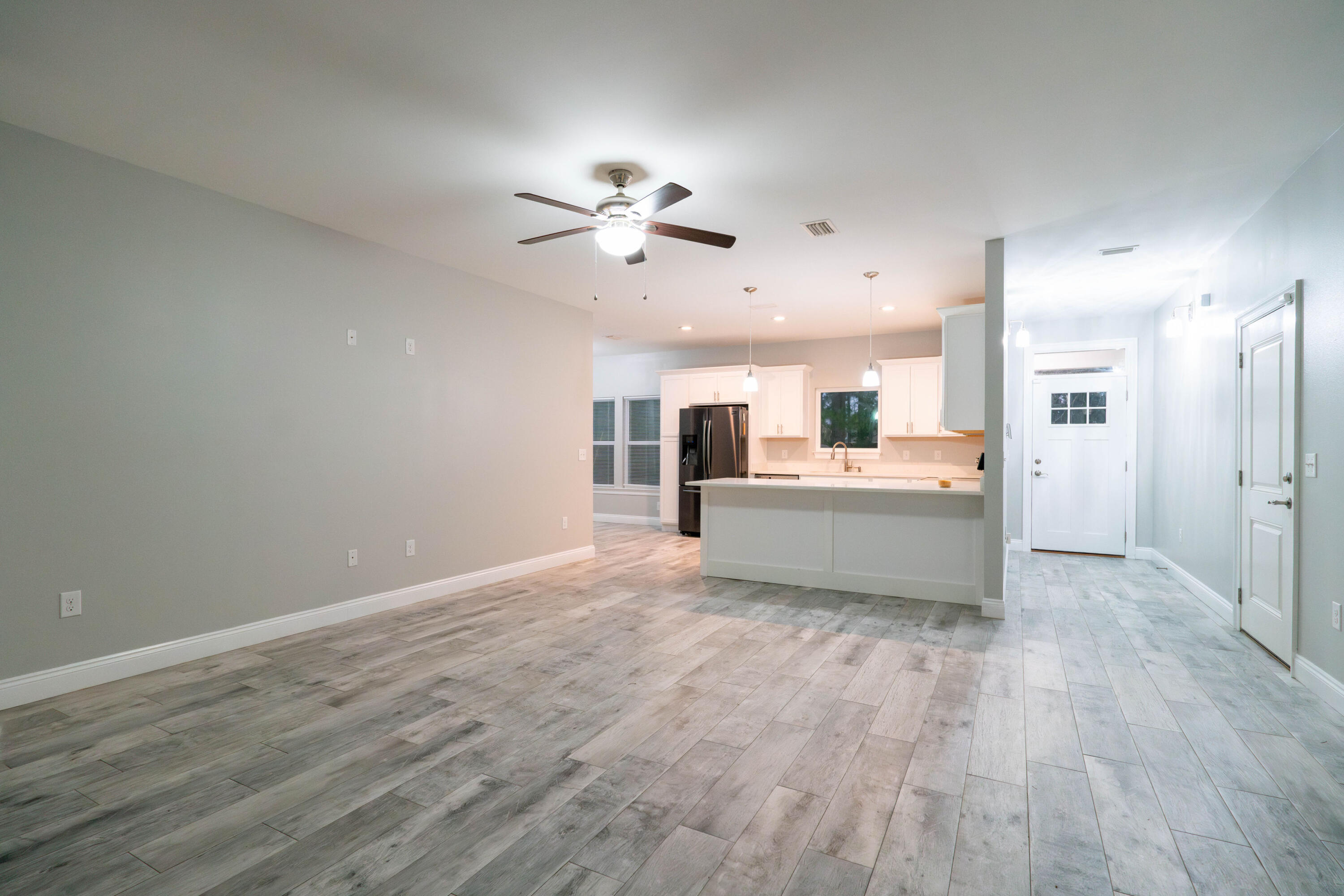 2243 Wind Trace Road North Navarre, FL 32566 - Photo 7 of 34 a view of a kitchen with a sink a kitchen counter space and a refrigerator