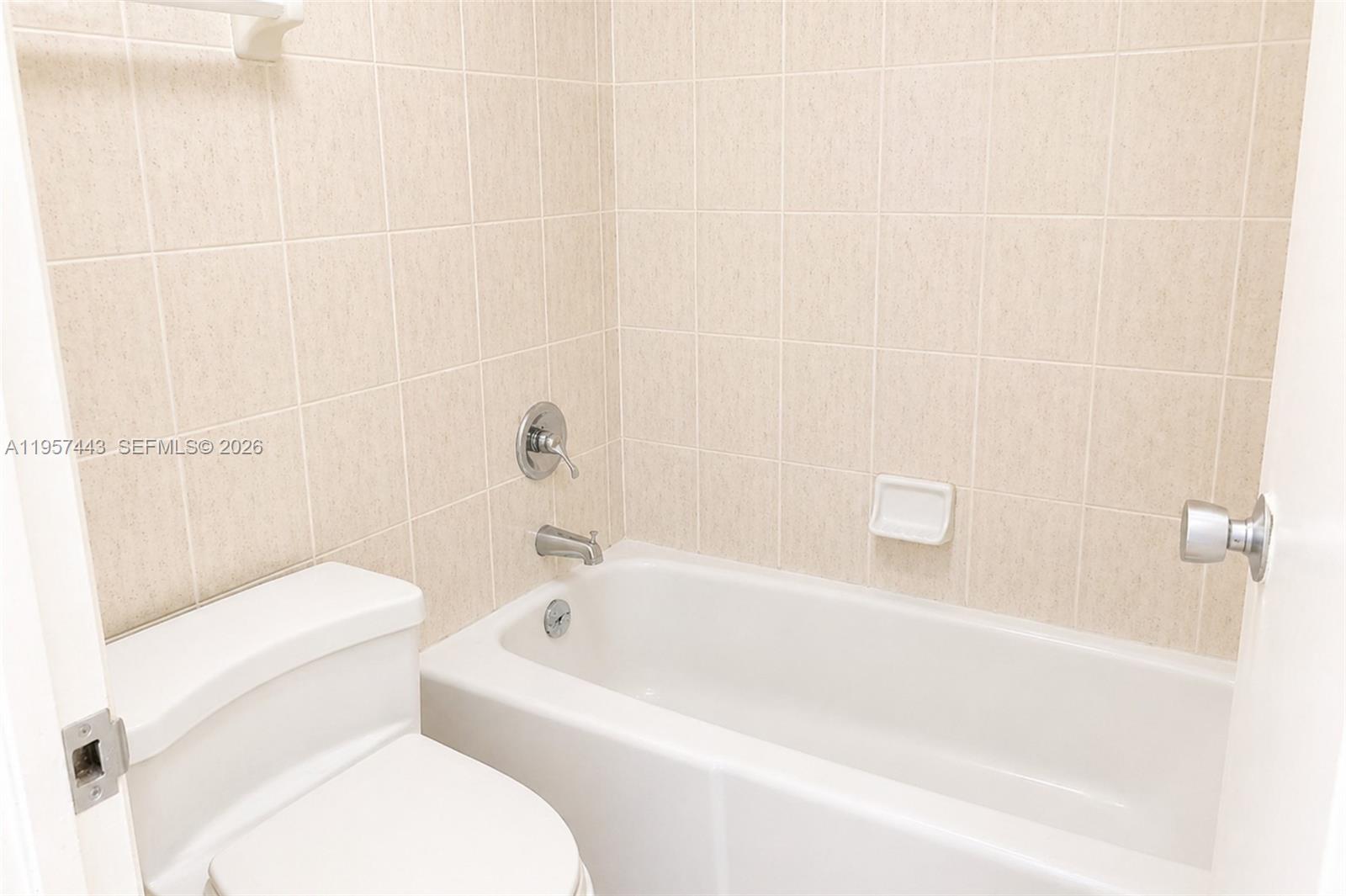 100 Lincoln Road, Unit 732 Miami Beach, FL 33139 - Photo 12 of 20 a white bath tub sitting next to a white toilet