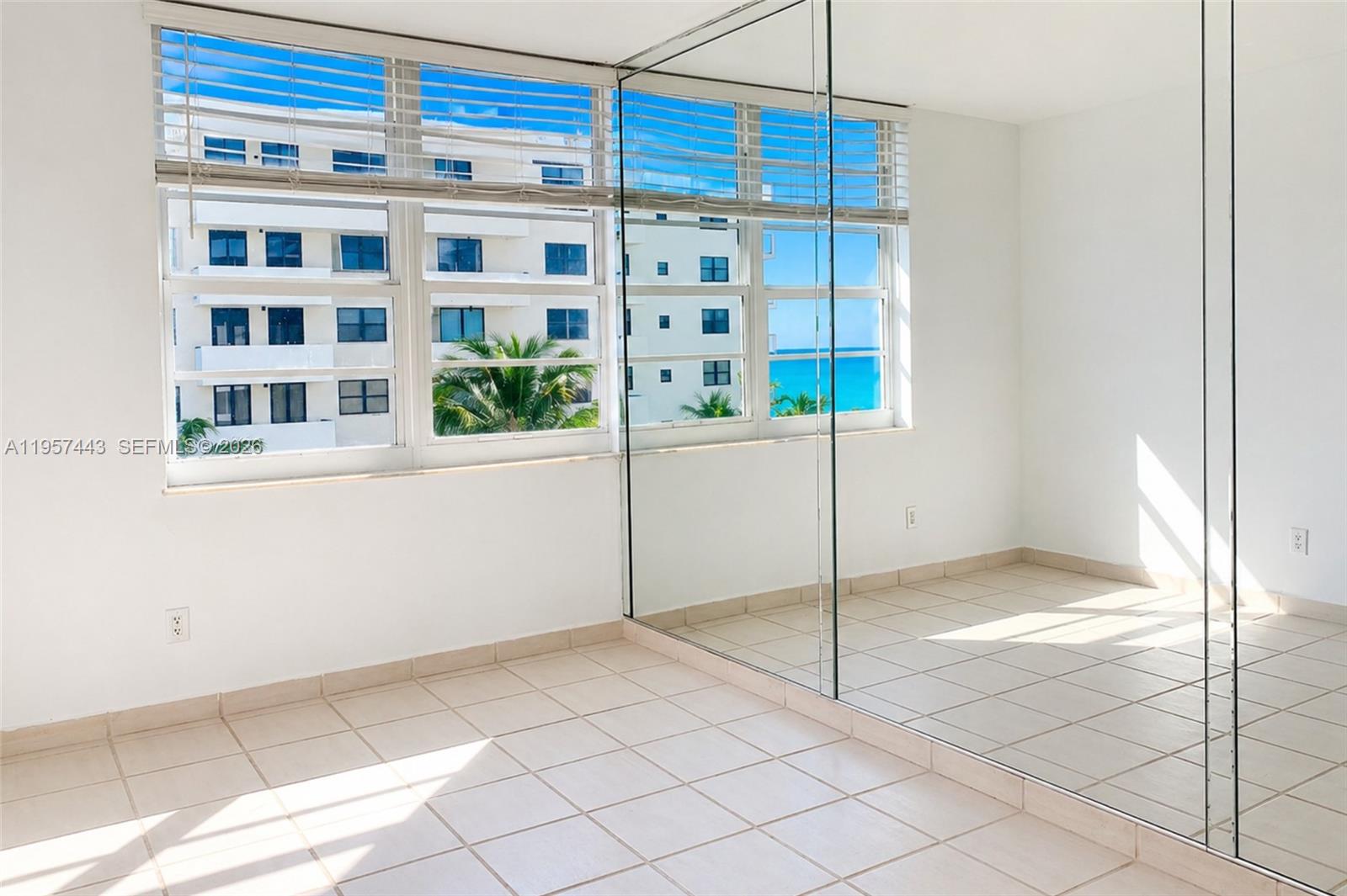 100 Lincoln Road, Unit 732 Miami Beach, FL 33139 - Photo 2 of 20 a view of a bedroom with a window and a ceiling fan
