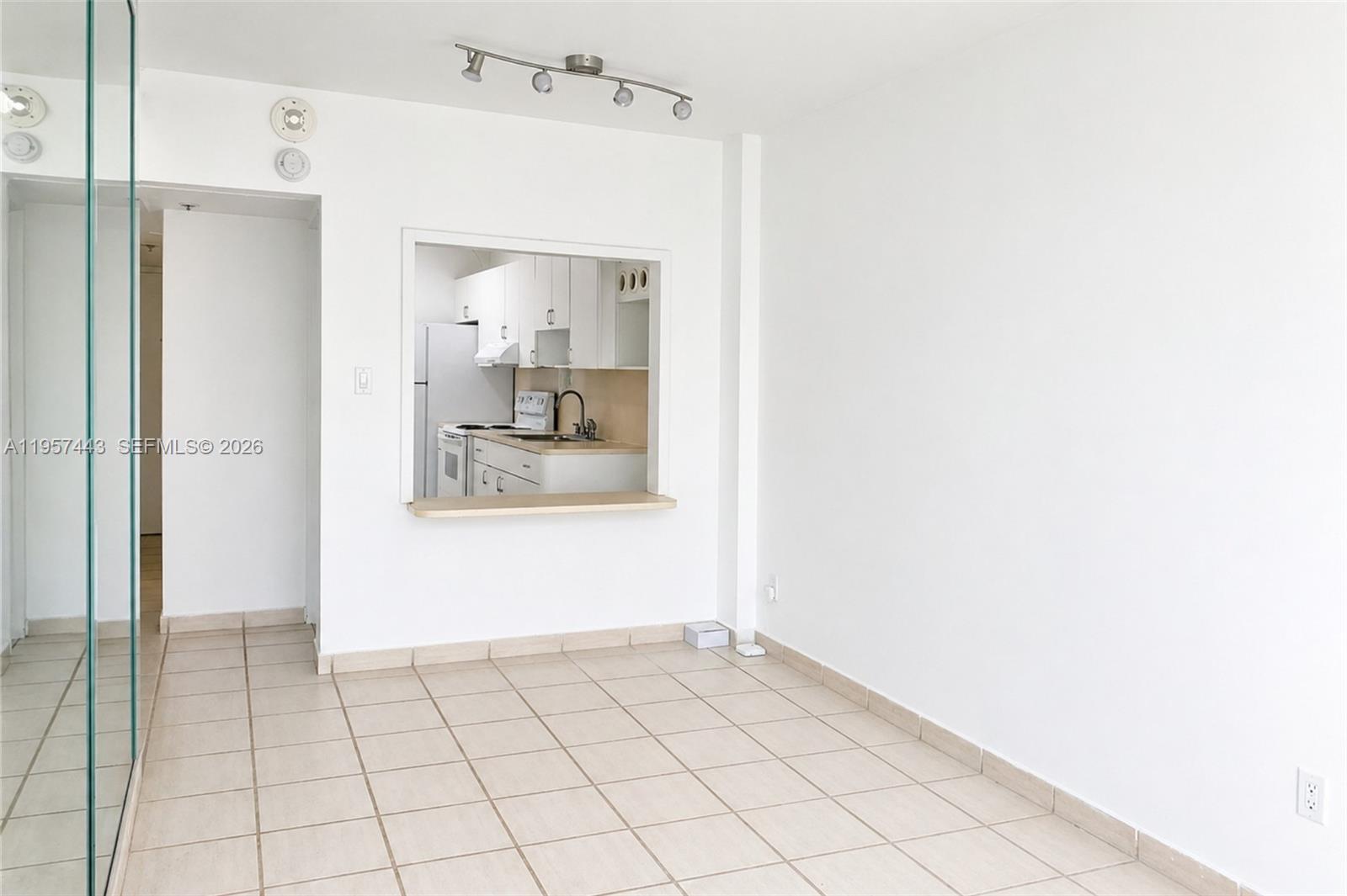 100 Lincoln Road, Unit 732 Miami Beach, FL 33139 - Photo 3 of 20 a view of a refrigerator in kitchen and an empty room