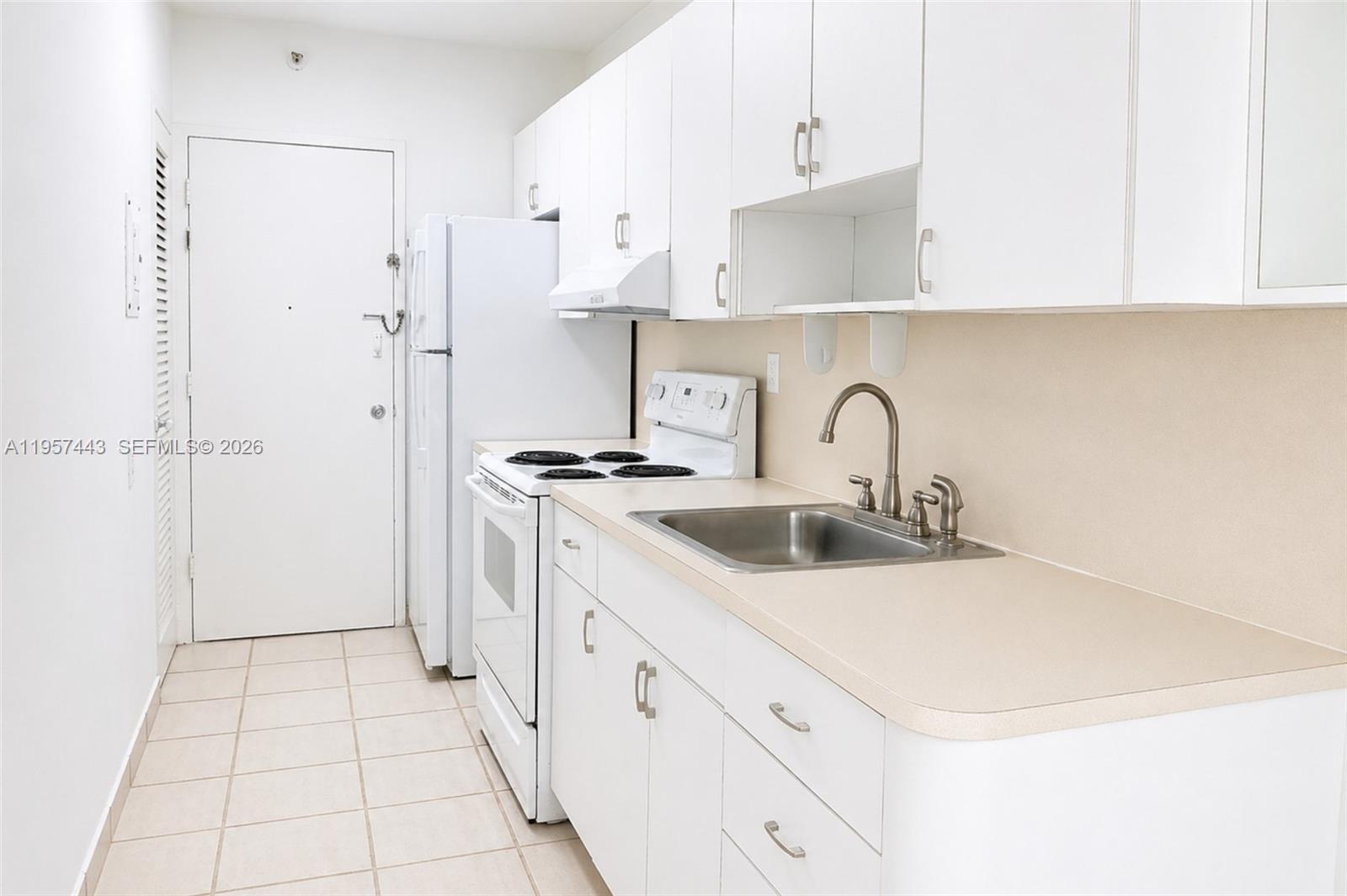 100 Lincoln Road, Unit 732 Miami Beach, FL 33139 - Photo 6 of 20 a kitchen with a sink appliances and cabinets