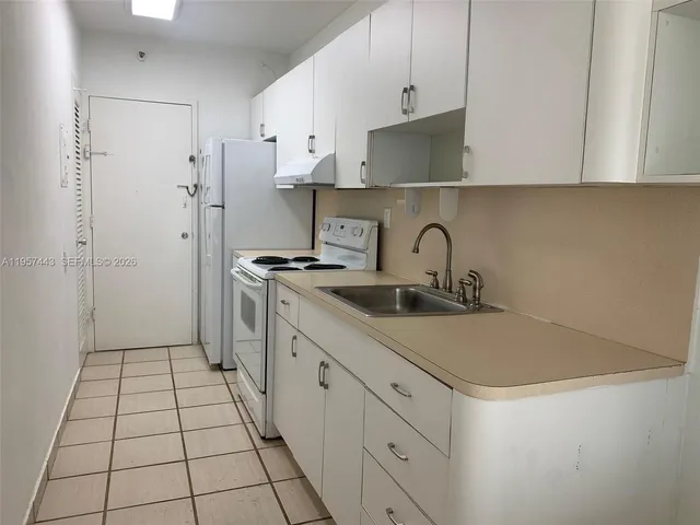 a kitchen with a microwave a stove and a refrigerator