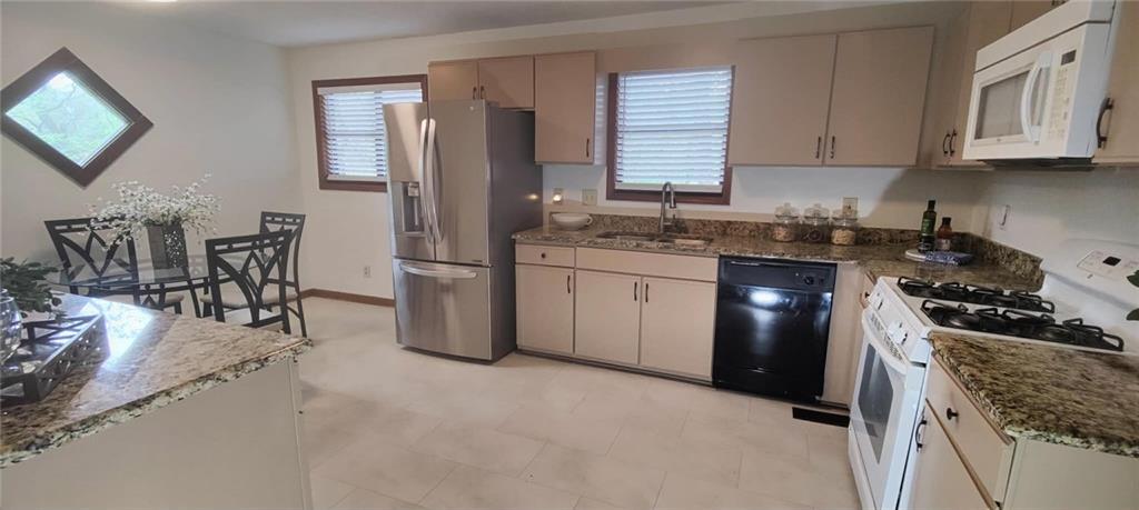 340 Farm Path Roswell, GA 30075 - Photo 7 of 21 a kitchen with granite countertop a sink stove top oven and cabinets