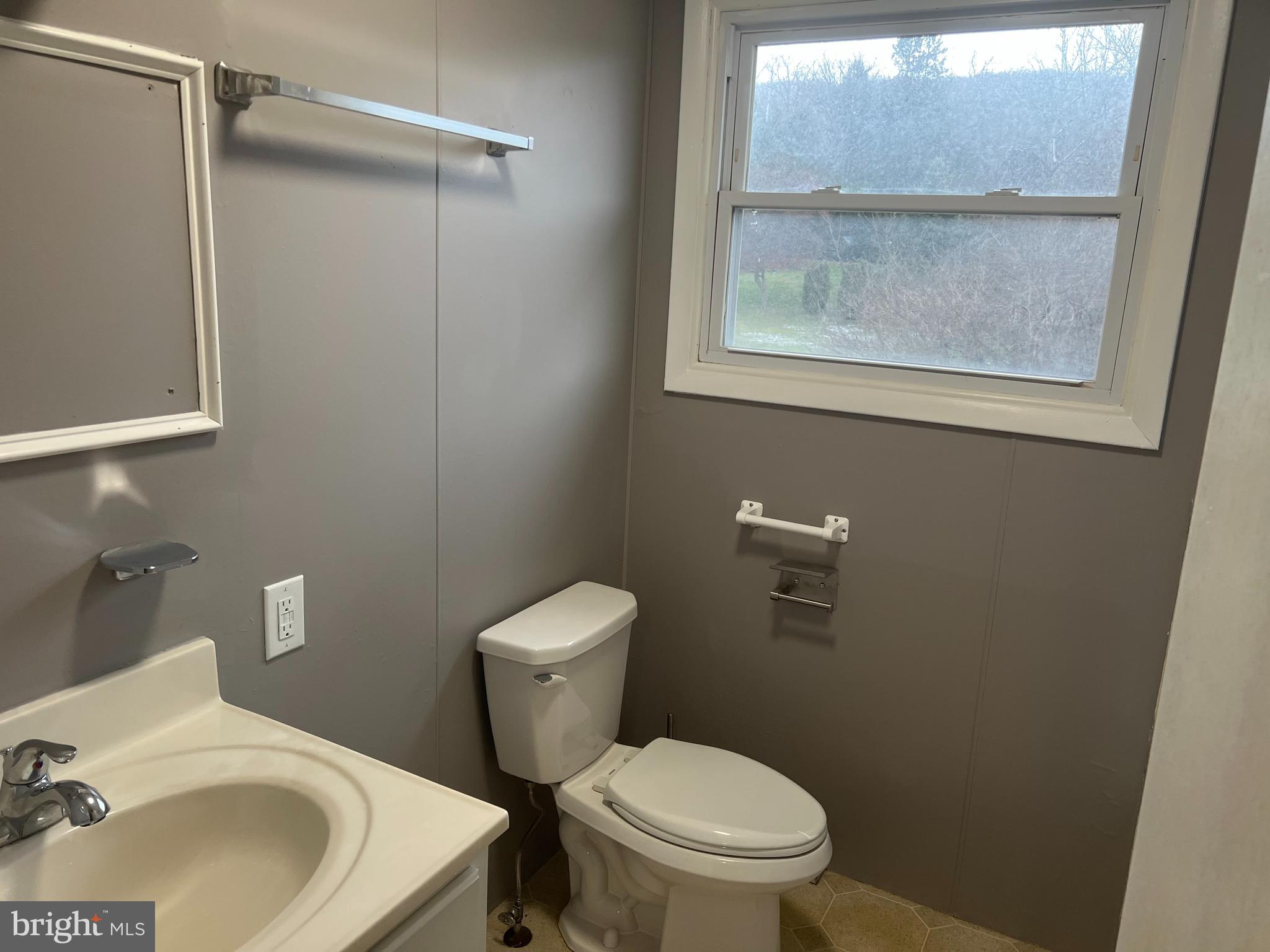 3015 Marion Street Reading, PA 19605 - Photo 7 of 11 a bathroom with a sink toilet and a mirror