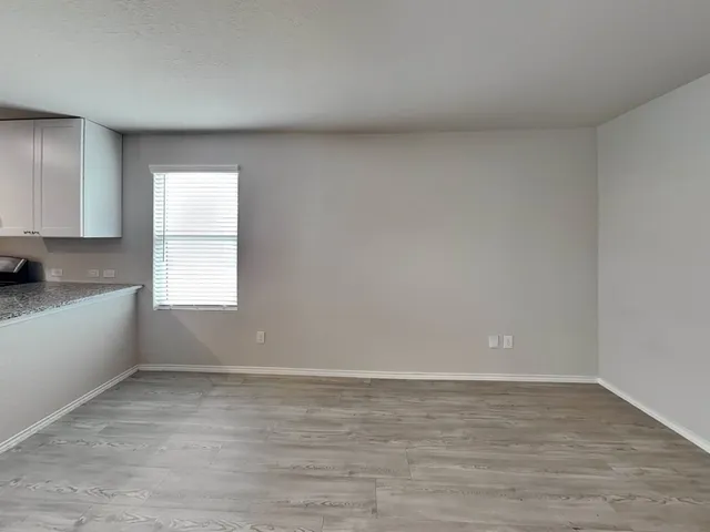 an empty room with wooden floor