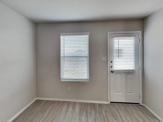 a kitchen with granite countertop a refrigerator and a sink