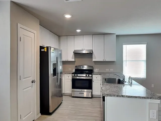 an empty room with windows and closet