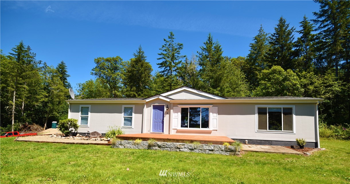 267 East Victor Road Belfair, WA 98528 - Photo 2 of 27 a front view of house with yard and seating area