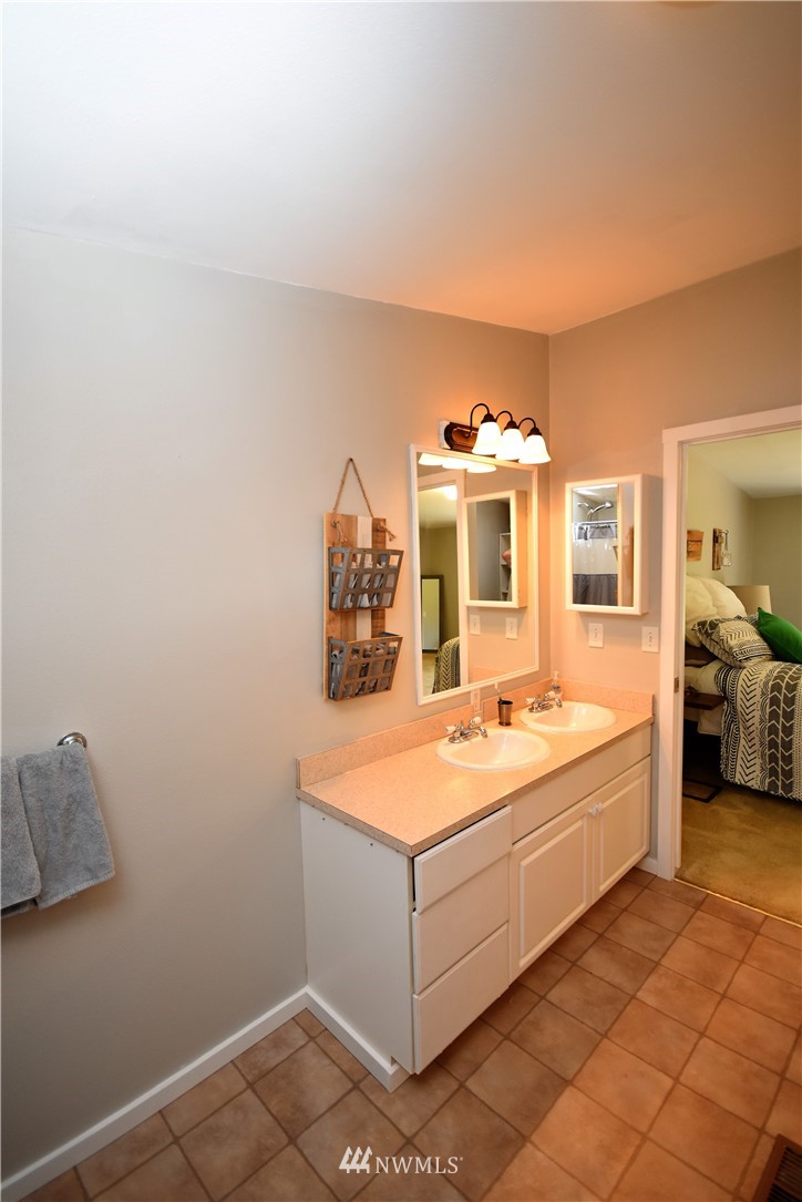 267 East Victor Road Belfair, WA 98528 - Photo 20 of 27 a room with a bed and a large mirror on a dresser