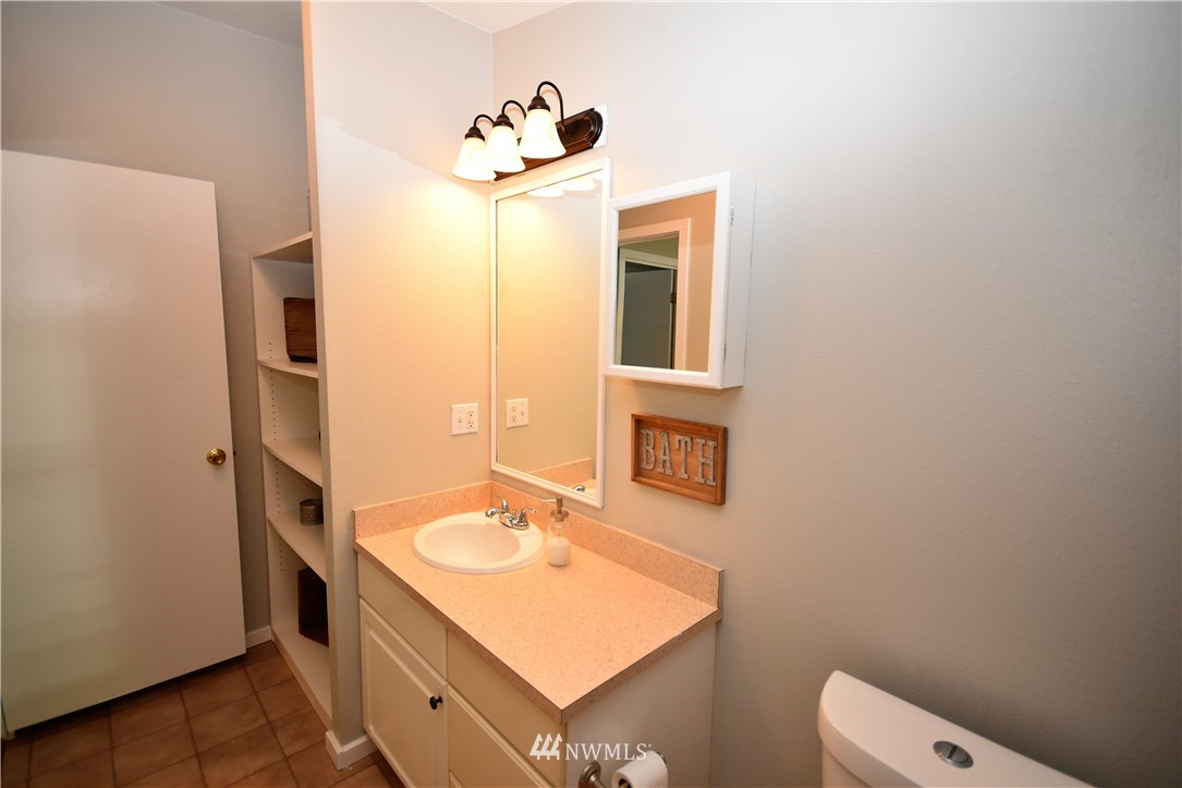 267 East Victor Road Belfair, WA 98528 - Photo 22 of 27 a bathroom with a sink and a mirror